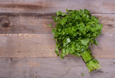 Ahşap zemin üzerinde küçük bir buket taze kenza yakın plan 