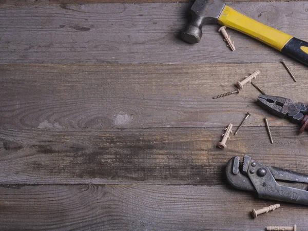 Ahşap arka planda üst görünümü onarmak için el aletleri seti. Ögelerin yakın plan onarımı