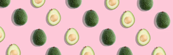 Avocado colorful pattern on a pastel pink background. — Stock Photo, Image