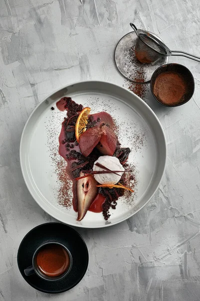 Poached pear with an ice cream in red wine sauce
