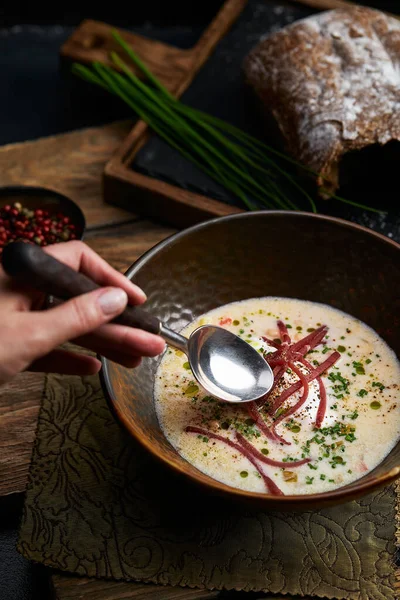 Traditional Italian soup with barley and bresaola on old wooden background. Selective focus. Dark tone. — Stock Image Traditional Italian soup with barley and bresaola on old wooden background. Selective focus. Dark tone. Royalty Free Stock Images