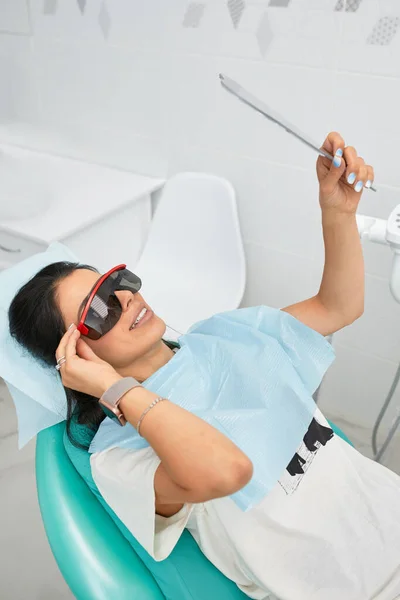 Overview of dental caries prevention.Woman at the dentists chair during a dental procedure. Beautiful Woman smile close up. Healthy Smile. Beautiful Female Smile