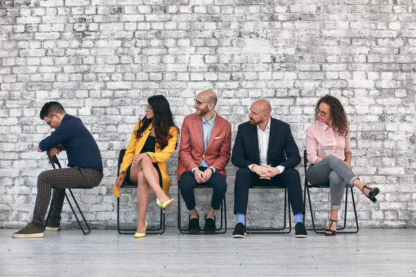 Corporate employees. Business matters discussion. Solid team ignoring lonely colleague.