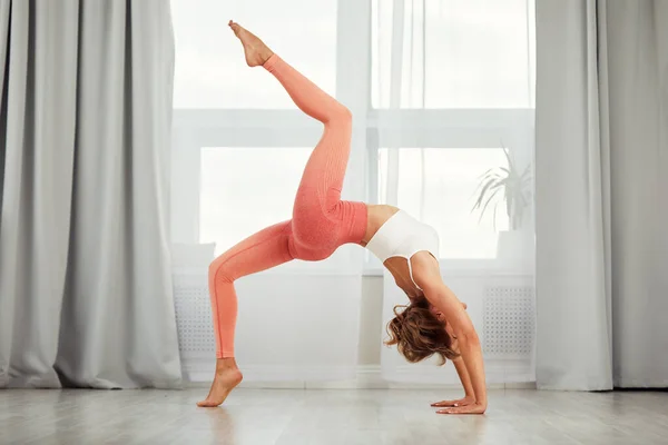 Fitness home. Beautiful woman doing some exercises at home in a living room. — Stock Photo, Image