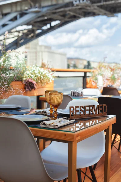 Reserved table sign in a restaurant on summer terrace