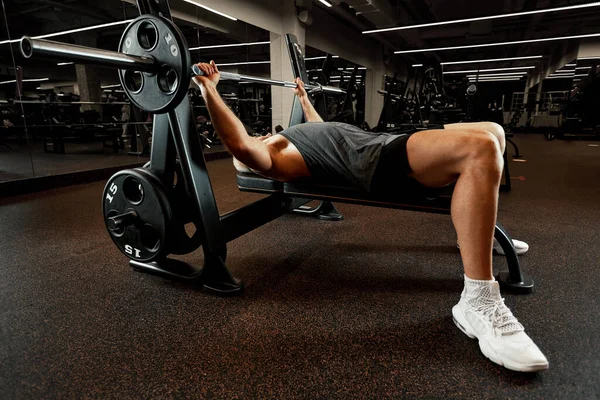 Closeup portrait of a muscular man workout with barbell at gym. Brutal bodybuilder athletic man with six pack, perfect abs, shoulders, biceps, triceps and chest — Stock Photo, Image