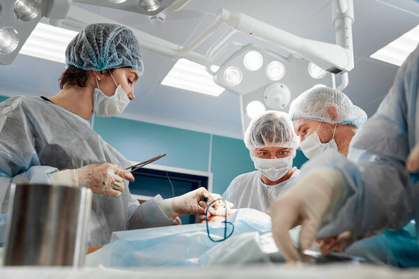 Team surgeon at work in operating room.