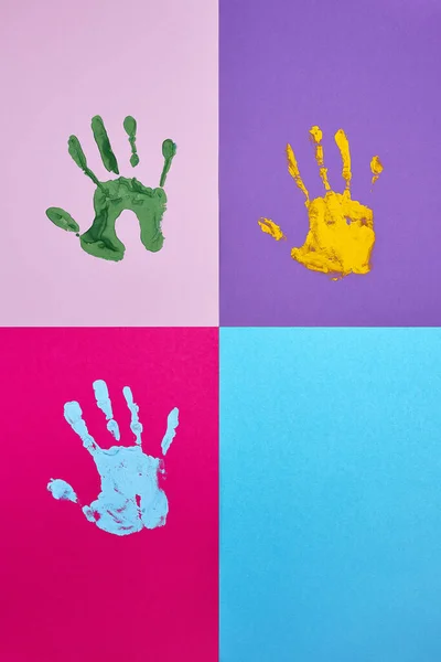 Set of colorful hand prints on different color background