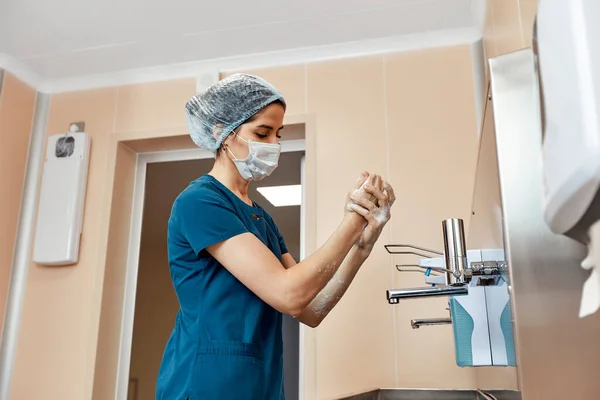 Woman doctor, washing her hands close-up, in the preoperative unit, disinfection of hands, plastic surgery