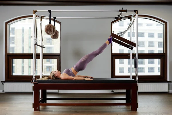 Modern equipment Cadilac reformer for Pilates in the gym, Concept of health and rehabilitation, instructor performs exercises on the reformer to correct the musculoskeletal system. — Stock Photo, Image