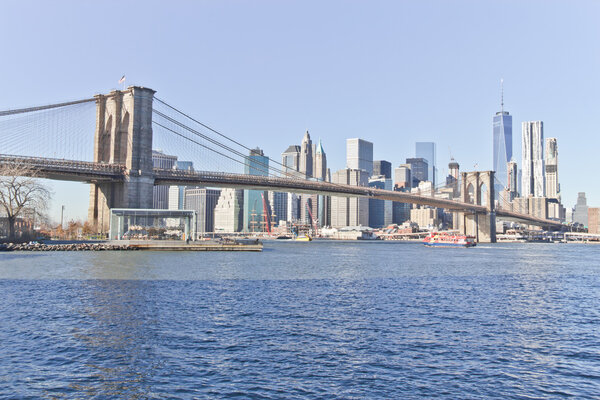 Brooklyn Bridge on winter morning with manhattan buildings in background.