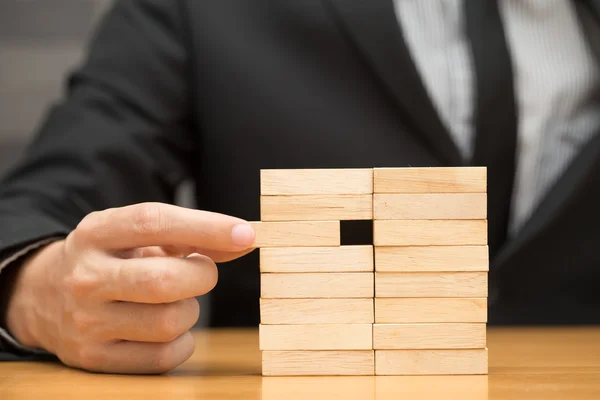 Alternative risk concept. Businessman choosing the wood block — Stock Photo, Image