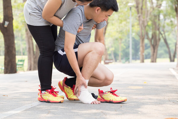 Sports injury. Man with twisted sprained ankle