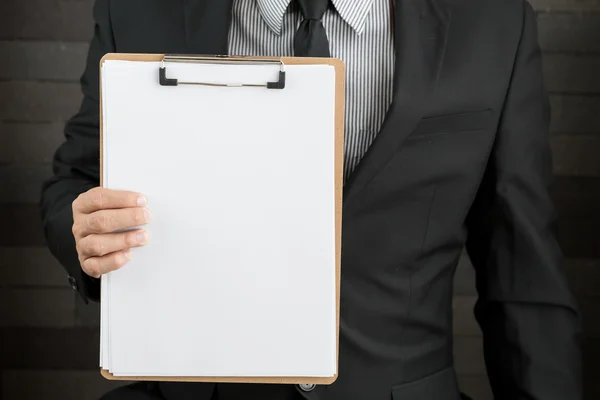 Businessman showing blank document — Stock Photo, Image