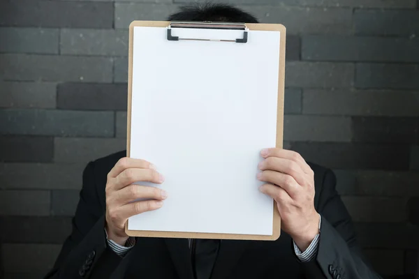 Businessman showing blank document — Stock Photo, Image