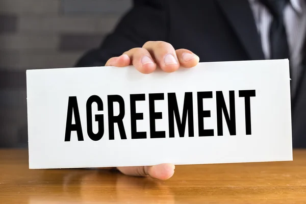 Agreement, message on white card and hold by businessman — Stock Photo, Image