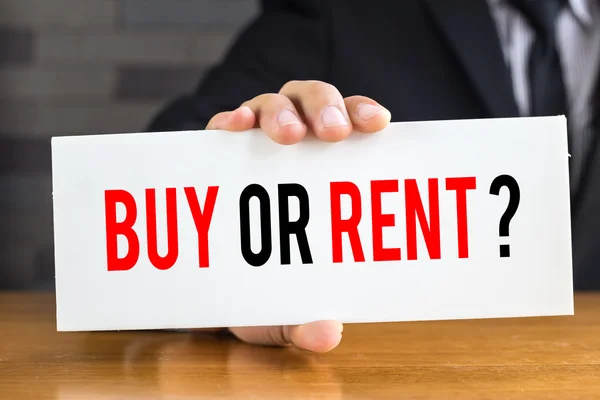 Buy or rent, message on white card and hold by businessman