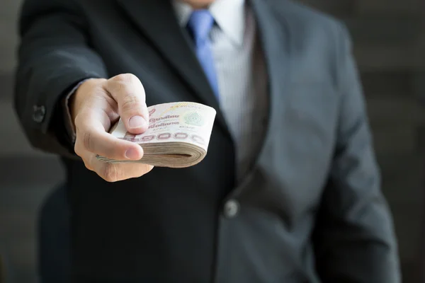 Businessman holding money thai baht — Stock Photo, Image