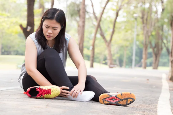 スポーツ傷害。ジョギング中に足首の痛みを持つ女性 — ストック写真