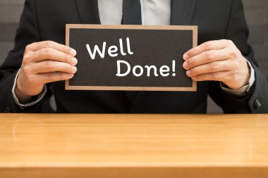 Bravo. Word'ün siyah afiş yazma ve businessm tarafından holding