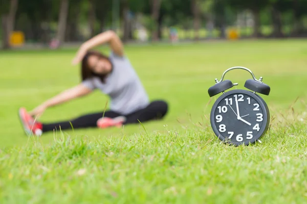 Morning  exercise and black clock — Stock Photo, Image