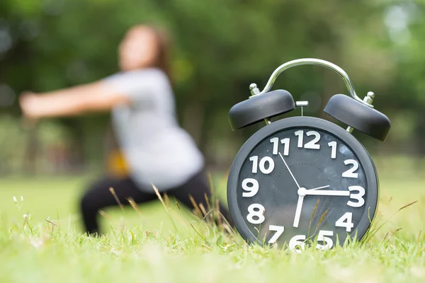 Morning  exercise and black clock — Stock Photo, Image