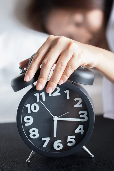 Asian woman sleeping on bed and wake up with alarm clock — Stock Photo, Image