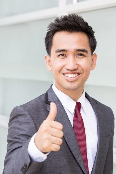 Asian businessman showing thumb up — Stok fotoğraf