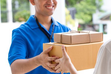 Woman hand accepting a delivery of boxes from deliveryman clipart
