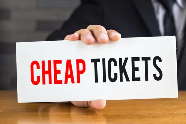 Cheap ticket, message on white card and hold by  businessman