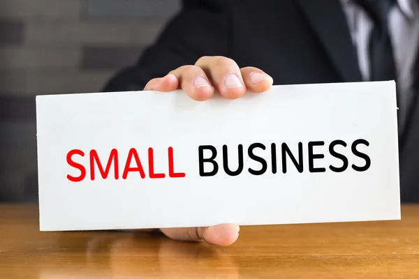 Small business, message on white card and hold by businessman