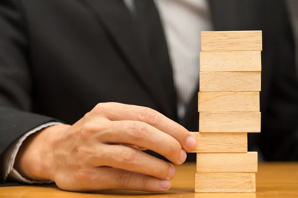 Alternative risk concept. Businessman choosing the wood block — Stock Photo, Image