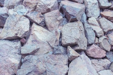 Close-up of rough stone texture. Natural gray stones close-up. Granite stones.