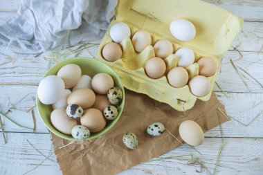 Fresh farm eggs in rustic style on a wooden table. Assortment of fresh farm eggs.