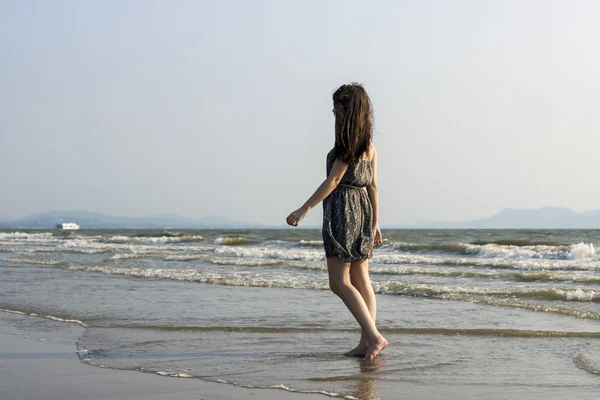 Young woman walking on tropical sea coast