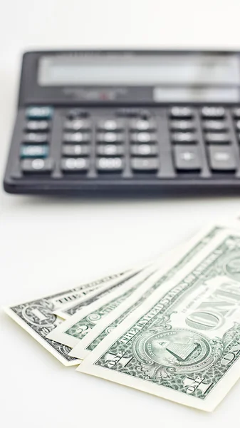 Several dollars and calculator — Stock Photo, Image