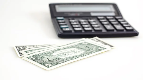 Kilka dolarów i kalkulator — Zdjęcie stockowe