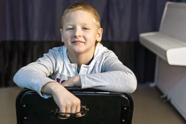 Jongen in de buurt van witte piano — Stockfoto