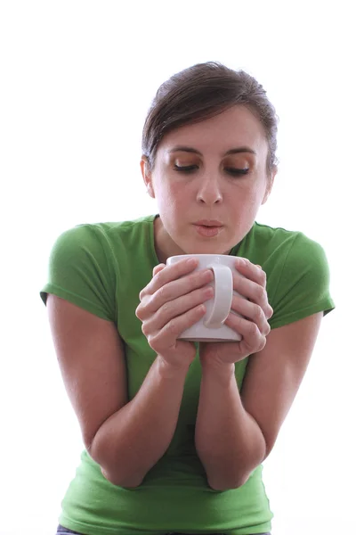 Female blowing air into a mug — Stock Photo, Image