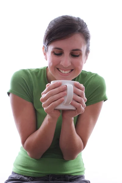 Female smiling into a mug — Stock Photo, Image
