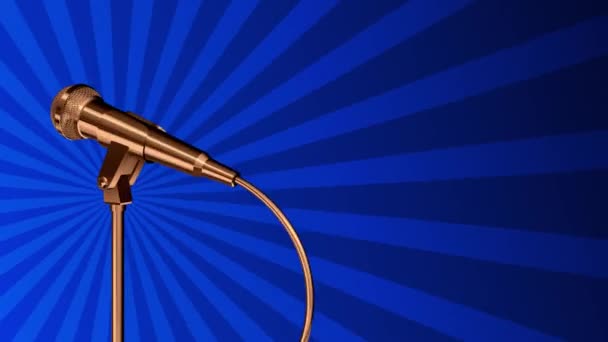 Golden microphone rotating on a stand. Light rays are spinning on a blue background. Seamless looping — Stock Video