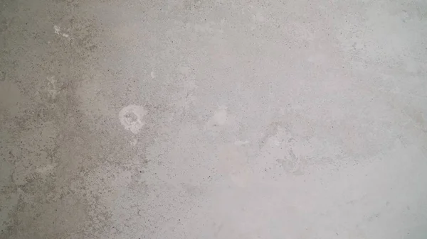 Gray cement floor texture. repair work. Floor priming with cement mortar. Texture of old gray concrete wall for background. The texture of a primed concrete floor.