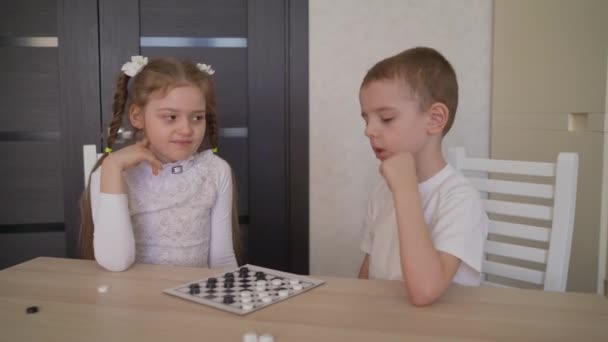 Children Play Checkers At The Table Brother And Sister Play Checkers Together Bending Over The Board Video By C Rusrussid2 Stock Footage Children Play Checkers At The Table Brother And Sister Play Checkers Together Bending Over The Board Video By C Rusrussid2 Stock Footage