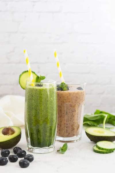 Healthy drinks food. Fresh pink and green smoothie. Spinach smoothie with cucumber and banana smoothie with berries, detox