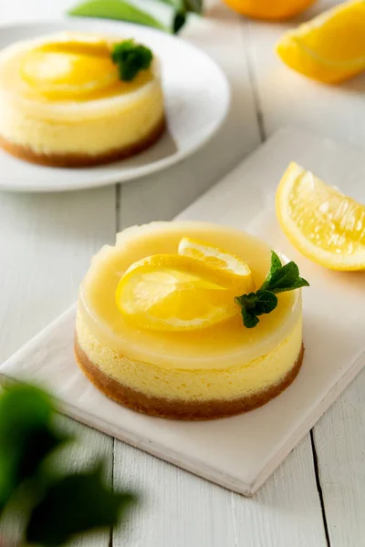 Cheesecake lemon tart cake or pie, with fresh lemon and mint. White background, lifestyle healthy sweet food
