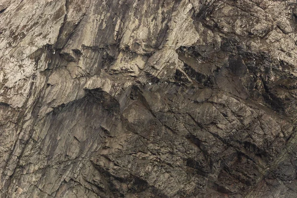Kaya dokusu ve yüzey arkaplanı. Çatlak ve yıpranmış doğal taş zemin.