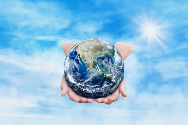 Ecology Concept : Hand holding blue earth in blue sky and white clouds. (Elements of this image furnished by NASA.)