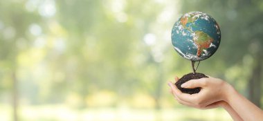 Ekoloji ve Çevre Konsepti: Arka planda yeşil doğal yeşil bir gezegen olan mavi gezegeni tutan el. (NASA tarafından desteklenen bu görüntünün elementleri.)