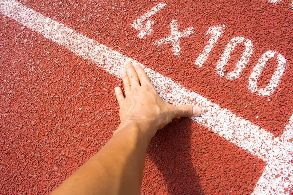 Hands on starting line — Stock Photo, Image