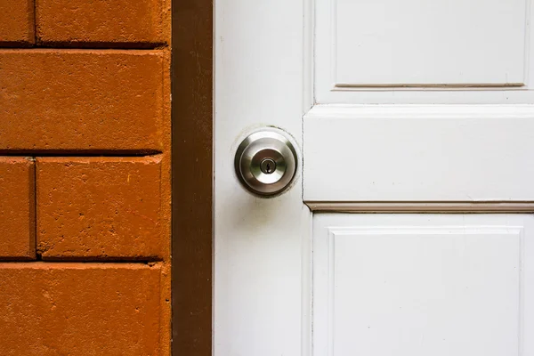 Aluminum door knob on the white door